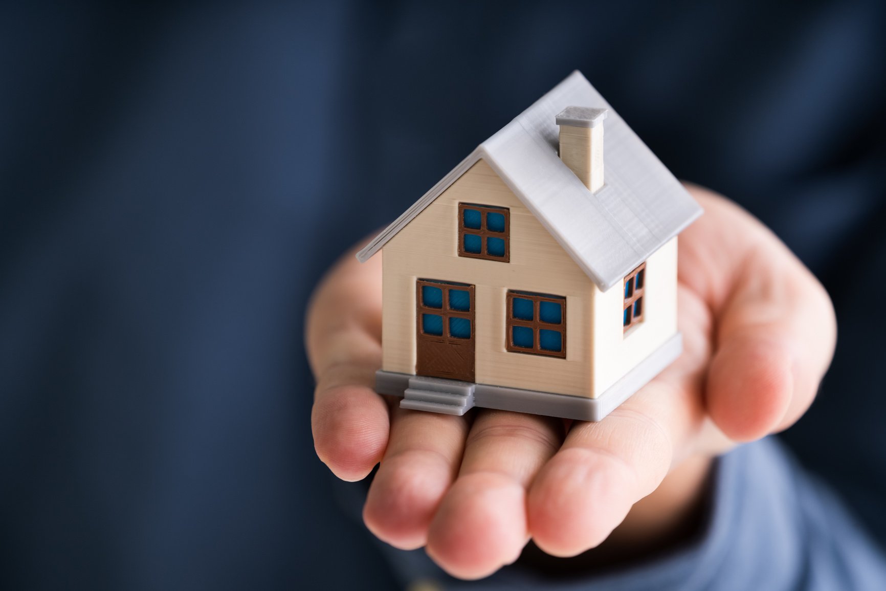 Businessman Holding House Model